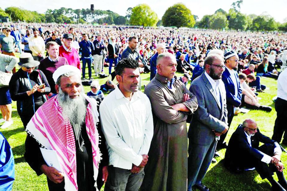 People attend the national remembrance service for victims of the mosque attacks, at Hagley Park in Christchurch, New Zealand on Friday.