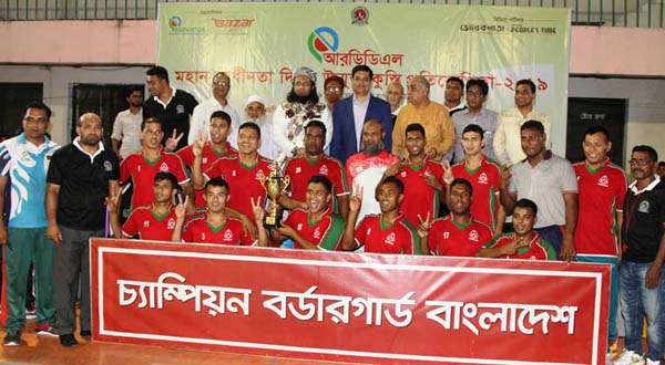Members of Border Guard Bangladesh, the champions of the RDDL Independence Day Wrestling (Men's) Competition with the guests and officials of Bangladesh Amateur Wrestling Federation pose for a photo session at the Shaheed Captain M Mansur Ali National Ha