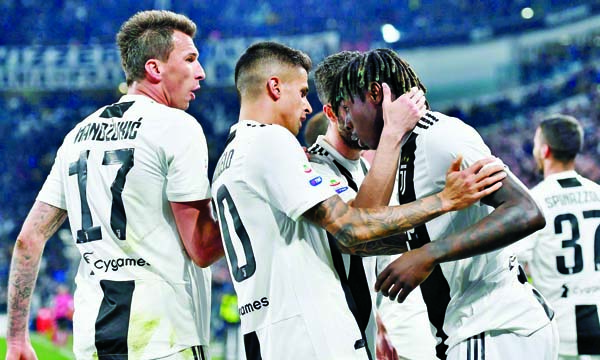 Juventus' Moise Kean (right) celebrates with teammates Joao Cancelo and Mario Mandzukic (left) after scoring during the Serie A soccer match between Juventus and Empoli at the Turin Allianz Stadium, Italy on Saturday.