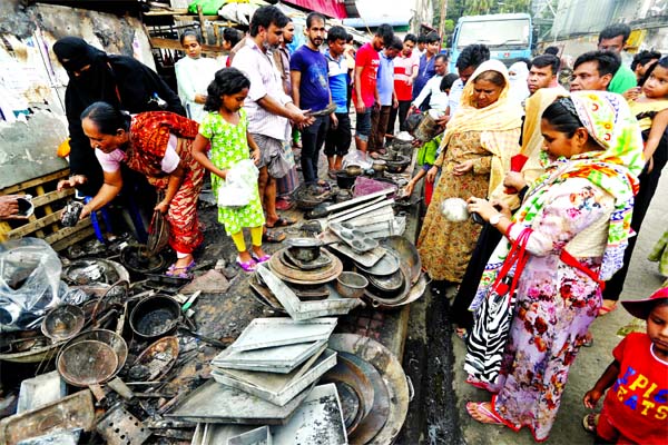 Fire affected traders and their families trying to sell their burnt stationeries like crockeries, cosmetics in cheaper rate at Gulshan DNCC kitchen market on Sunday.