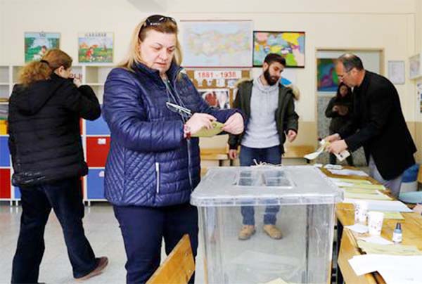 A woman casts her ballot at a polling station during the municipal elections in Ankara, Turkey on Sunday.