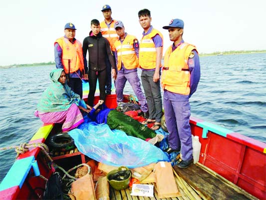 NARAYANGANJ: Members of Coast Guard conducting rescue operation after a trawler capsized in Meghna River carrying 17 polling officials due to nor'wester on Sunday evening.
