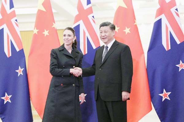 China's President Xi Jinping shakes hands with New Zealand's Prime Minister Jacinda Ardern before their meeting at the Great Hall of the People in Beijing on Monday