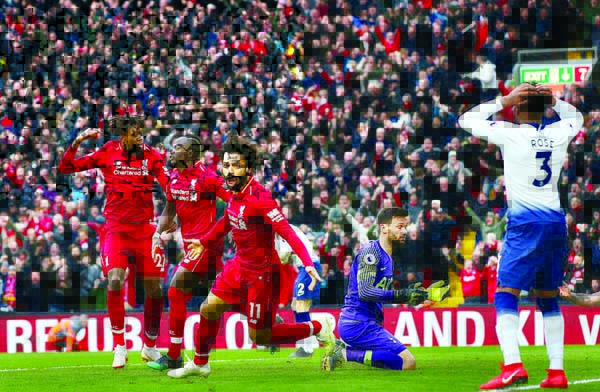 Mohamed Salah of Liverpool FC celebrates after Toby Alderweireld of Tottenham Hotspur had scored an own goal for their second goal during the Premier League match between Liverpool and Tottenham Hotspur at Anfield on Sunday.