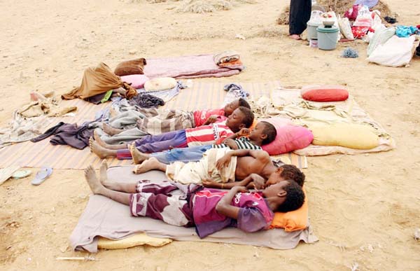 Yemeni children who fled fighting between Yemen's armed rebels, known as the Huthis, and pro-government forces in Bani Hasan near the border with Saudi Arabia, gather in a makeshift camp in the district of Abs, in Yemen's northwestern Hajjah province on