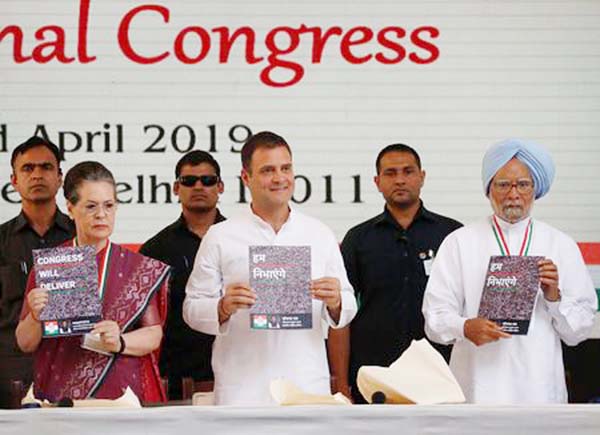 Rahul Gandhi Â©, President of India's main opposition Congress party, his mother and leader of the party Sonia Gandhi and India's former Prime Minister Manmohan Singh Â® display copies of their party's election manifesto for the AprilMay general e