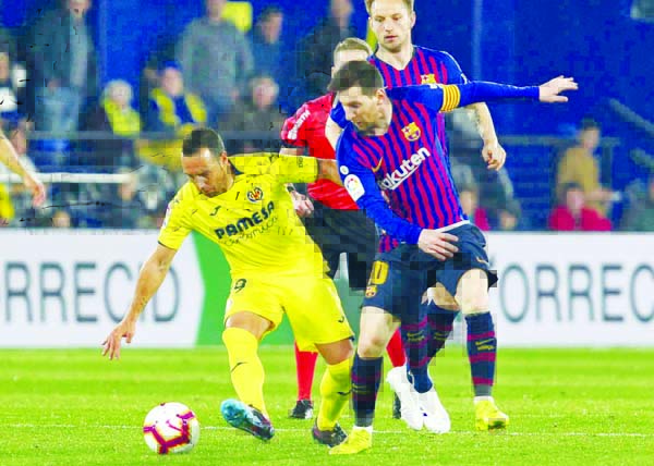 Barcelona forward Lionel Messi (right) vies for the ball with Villarreal's Santi Cazorla during the Spanish La Liga soccer match between Villarreal and FC Barcelona at the Ceramica stadium in Villarreal, Spain on Tuesday.