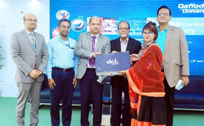 Prof Dr Syed Akhter Hossain, Head, Department of Computer Science & Engineering of Daffodil International University handing over a laptop to a student at Free Laptop Distribution Ceremony held at the University on Monday.