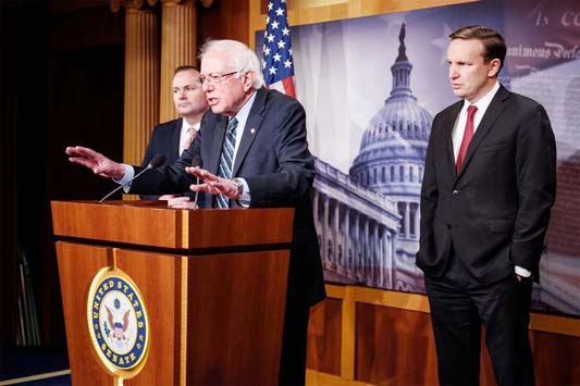 Sen. Bernie Sanders (I-VT), flanked by Sens. Mike Lee (R-UT) and Chris Murphy (D-CT), speaks after the Senate voted to withdraw support for Saudi Arabia's war in Yemen.