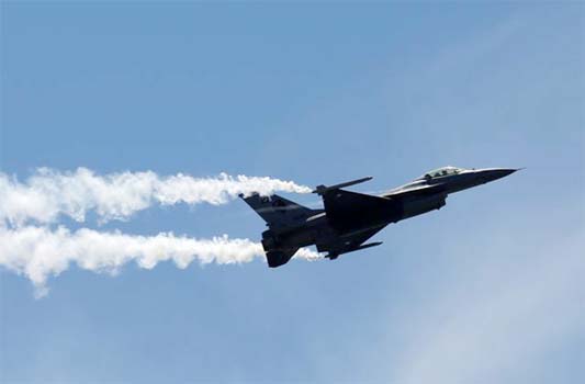 Pakistan Air Force (PAF) Sherdils (Lion Heart) squad's fighter jet F-16 flies during Pakistan Day celebrations, Clifton beach, Karachi.