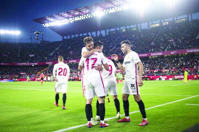 Sevilla's Spanish midfielder Pablo Sarabia is congratulated by teammates for his goal during the match between Sevilla FC and Deportivo Alaves at the Ramon Sanchez Pizjuan stadium in Seville on Thursday.