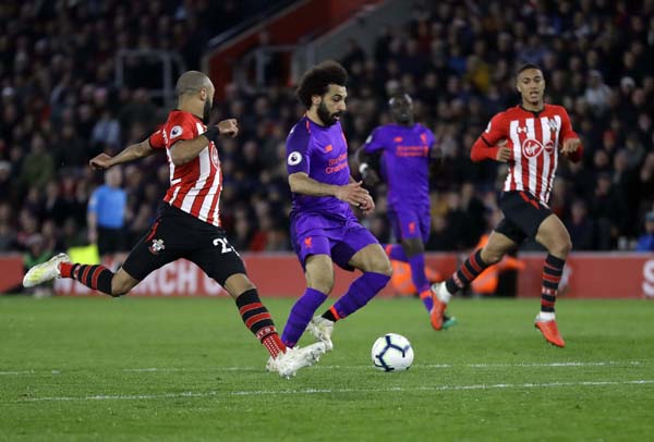 Liverpool's Mohamed Salah (center) scores his side's second goal during the English Premier League soccer match between Southampton and Liverpool at St Mary's stadium in Southampton, England on Friday.