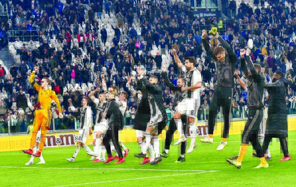 Juventus celebrate their victory at the end of the Italian Serie A soccer match between Juventus and AC Milan at the Allianz Stadium in Turin, Italy on Saturday.