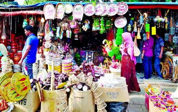 A wide varieties of handicrafts, including pots, earthen wares and ornaments are put on display ahead of the Pahela Baishakh, the first day of Bangla New Year, at the makeshift shops in front of Shishu Academy in the capital. This photo was taken on Sunda