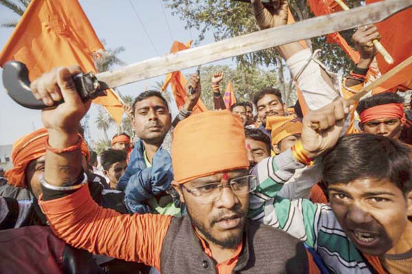Hindu hardliners, one holding a sword, chant slogans against Muslim communities during a rally demanding a Hindu temple be built on a site in northern India where hardliners in 1992 had attacked and demolished a 16th century mosque in Ayodhya Uttar Prades