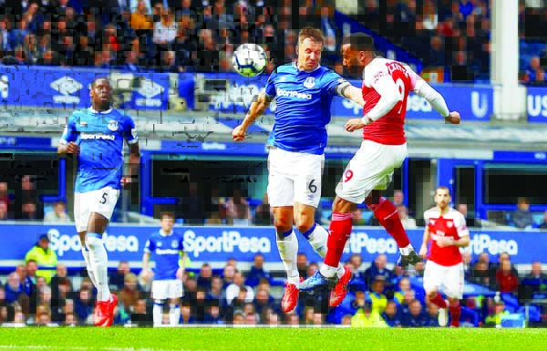 Arsenal's Alexandre Lacazette (Right) in action with Everton's Phil Jagielka during their Premier League match at Goodison Park on Sunday.
