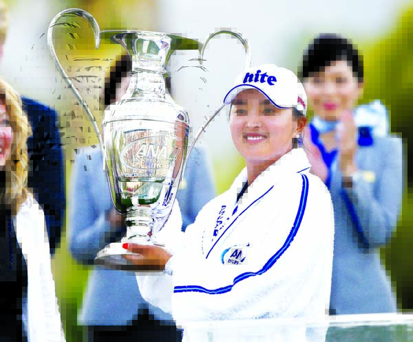 Ko Jin Young of South Korea poses with the Dinah Shore Trophy after winning the LPGA Tour ANA Inspiration golf tournament at Mission Hills Country Club in Rancho Mirage, Calif on Sunday.