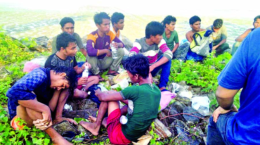 Dozens of people, believed to be Rohingya Muslims from Myanmar who were dropped off from a boat are pictured on a beach near Sungai Belati, Perlis, Malaysia in this undated handout photo released April 8, 2019.