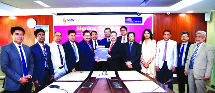 Mostafa Jalal Uddin Ahmed, AMD of South Bangla Agriculture and Commerce (SBAC) Bank Limited and MM Monirul Alam, CEO of Guardian Life Insurance, exchanging an agreement signing document at the Bank's head office in the city recently. Under the deal, Suro