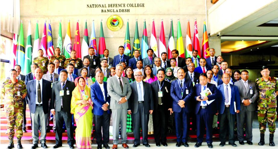 Prime Minister's Economics Affairs Adviser Dr. Mashiur Rahman poses for a photo session with the participants of a seminar on 'Environmental Security and Climate Change-Challenge of Development for Bangladesh' in the auditorium of NDC in the city's M