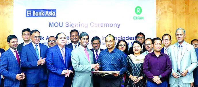 Md. Arfan Ali, Managing Director of Bank Asia Limited and Dipankar Dutta, Country Director of Oxfam-Bangladesh, exchanging an agreement signing document on Promoting Access to Finance (A2F) to Rural Based Micro, Small and Medium Enterprises (MSMEs) to ben