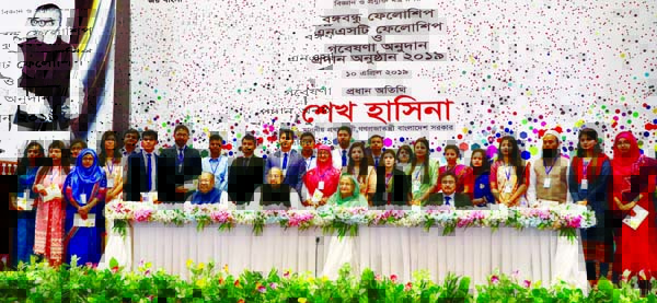 Prime Minister Sheikh Hasina poses for a photo session with fellows at a cheque distribution for Bangabandhu Science and Technology Fellowship, NST Fellowship and other special research organised by Science and Technology Ministry at Bangabandhu Internati