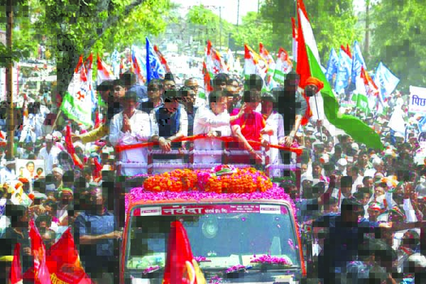 Congress party chief Rahul Gandhi, (center) in white, accompanied by his sister Priyanka Vadra in red arrives to file his nomination papers for the upcoming general elections in Amethi, Uttar Pradesh state, India.