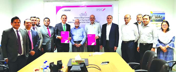 Mominul Islam, Managing Director of IPDC Finance Limited and Ali Hussain Akbar Ali, Chairman of BSRM Steels Limited, exchanging an agreement signing document to on-board on "ORJON", the first ever Digital Supply Chain Platform powered by Blockchain tech