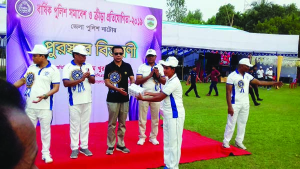 M Khurshid Hossain, Deputy Inspector General of Police, Rajshahi Range distributes the prize to a winner of the Annual Sports Competition of Natore Police at Bara Harishpur Police Lines Ground in Natore City on Wednesday.