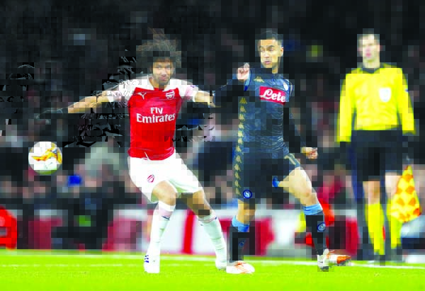Arsenal's Alex Iwobi (left) challenges for the ball with Napoli's Elseid Hysaj during the Europa League, first leg quarterfinal soccer match between Arsenal and Napoli at Emirates stadium in London on Thursday.