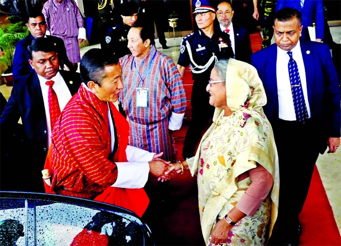 Prime Minister Sheikh Hasina receiving Bhutanese Prime Minister Dr Lotay Tshering at the Hazrat Shahjalal International Airport on Friday.