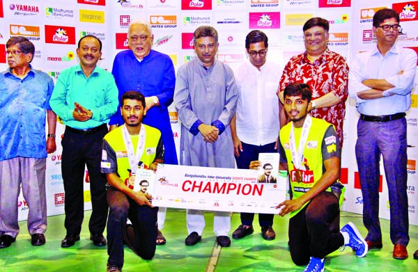 Md. Mukter Hossain and Al Amin Zuman of Daffodil International University, the champions of the men's doubles of the Badminton Competition of the Bangabandhu Inter-University Sports Championship pose for photograph with Noor-E-Alam Chowdhury, MP, Nahim R