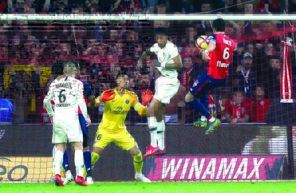 Lille's Jose Fonte (right) scores a goal during the French League One soccer match between OSC Lille and Paris-Saint-Germain at Stade Pierre Mauroy in Lille, France on Sunday.