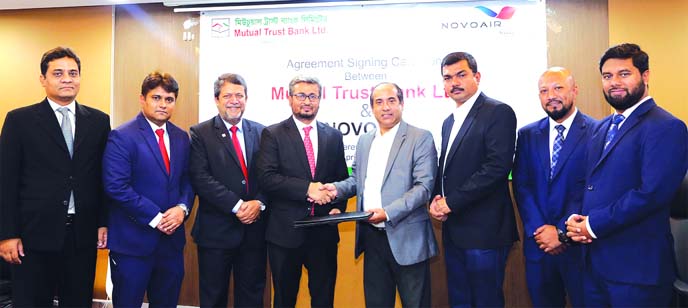 Mohammad Anwar Hossain, Head of Cards, Mutual Trust Bank Limited (MTB) and Mes-bah-ul Islam, Head of Marketing & Sales of NOVOAIR Limited, exchanging an agreement signing document at the Bank's corporate office in the city recently. Under the deal, credi