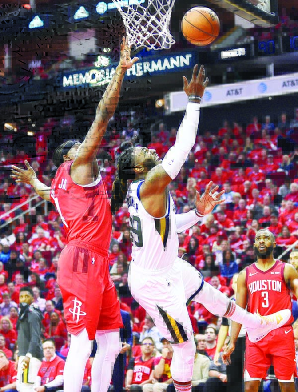 Utah Jazz forward Jae Crowder (right) shoots as Houston Rockets forward Danuel House Jr. defends during the second half of Game 1 of an NBA basketball first-round playoff series in Houston on Sunday. Houston won the game 122-90.