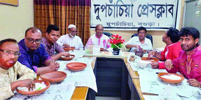 DUPCHANCHIA (Bogura): Leaders of Dupchanchia Press Club eating 'panta' and hilsa marking the Pahela Baishakh at the Club premises on Sunday.