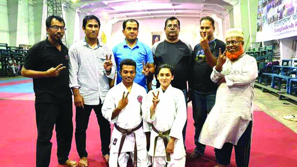 Maisha Rahman Promi (front right) and Md Monir Hossain Tanvir (front left), who clinched First Dan in Black Belt pose with Head Coaches of Bangladesh Karate De Union Md Alamgir Hossain, Syed Md Zakir Hossain, Vice-President of Karate De Union Mizanur Rahm