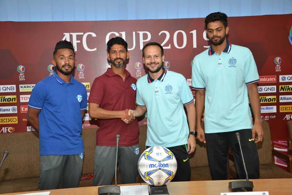 Head Coach of Dhaka Abahani Limited Mario Lemos (second from right) and Head Coach of Minerva Punjab of India Sachin Badadhe (second from left) shaking hands at the conference room of Bangladesh Football Federation House on Tuesday.