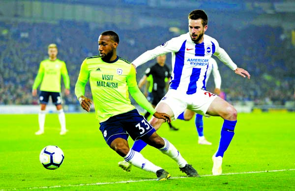 Cardiff City's Junior Hoilett and Brighton & Hove Albion's Davy Propper (right) battle for the ball during the English Premier League soccer match at the AMEX Stadium, Brighton, England on Tuesday.