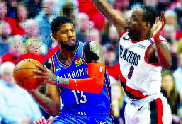 Oklahoma City Thunder forward Paul George (left) looks to pass the ball around Portland Trail Blazers forward Al-Farouq Aminu during the first half of Game 2 of an NBA basketball first-round playoff series in Portland, Ore on Tuesday.