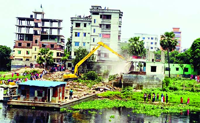 Several illegal buildings being bulldozed by BIWTA at Bhatulia Mouza on the bank of Turag River as part of continuous demolition drive on Wednesday.