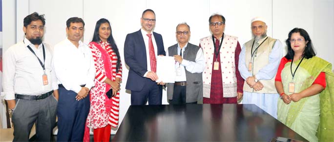 UGC Secretary Dr Md. Khaled and Dean of Applied Linguistics of ZHAW Prof Dr Daniel Perrin exchanging a MoU document on behalf of their organizations while UGC Chairman Prof Abdul Mannan was, among others, present on the occasion.