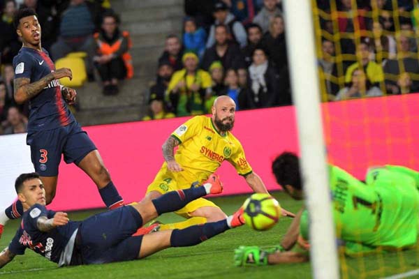 Nantes' French defender Nicolas Pallois (center) misses a shot during the French L1 football match between FC Nantes and Paris Saint-Germain (PSG) at the La Beaujoire stadium in Nantes, western France on Wednesday.