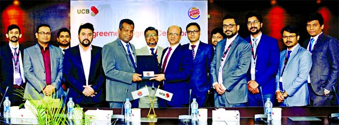 Md. Abdullah Al Mamoon, DMD of United Commercial Bank Limited (UCB) and M Jahangir Alam, Group CEO of Bangla Trac Limited who have secured the master franchise in Bangladesh for Burger King have signed an agreement at the Bnak's head office in the city r