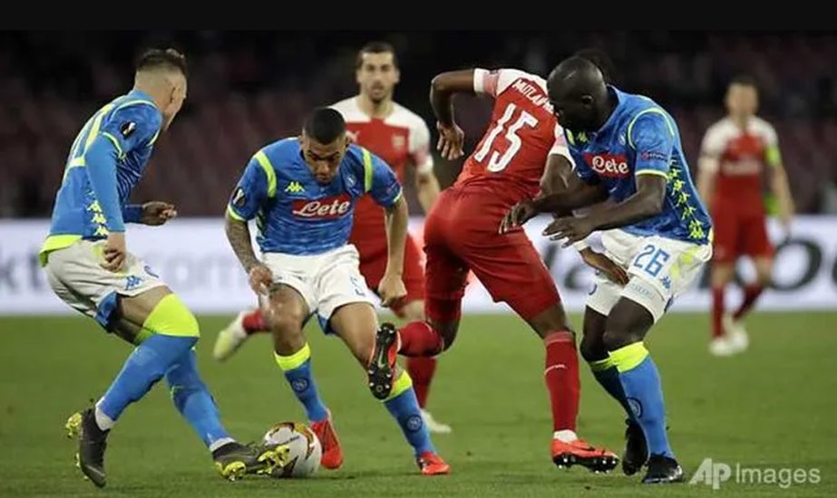Napoli's Marques Allan (2nd left) and Arsenal's Ainsley Maitland-Niles (2nd right) defend as Napoli's Kalidou Koulibaly (right) and Piotr Zielinski look on during the Europa League second leg quarter-final football match on Thursday.