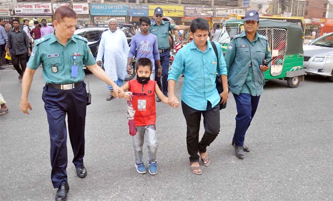 Harunur Rashid Hazari, DC Traffic helping pedestrians to cross the road during a special drive of CMP at GIC Crossing yesterday.