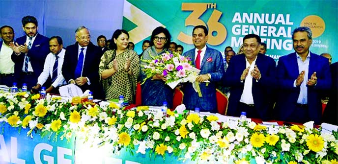 Md Siddiqur Rahman, outgoing President of Bangladesh Garment Manufacturers and Exporters Association (BGMEA), handing over the charge by giving flower bouquet to Rubana Huq, the first female elected president of the association after its 36th AGM at new o