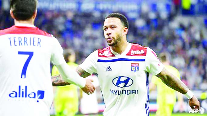 Lyon's Dutch forward Memphis Depay (R) reacts with French midfielder Martin Terrier during the French L1 football match against Angers in Decines-Charpieu, near Lyon, central-eastern France on Friday.