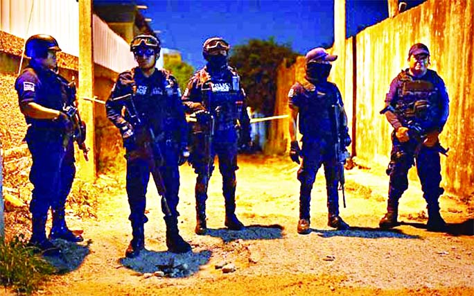 Police officers guard a crime scene where unidentified assailants opened fire at a bar in Minatitlan in Veracruz state of Mexico.