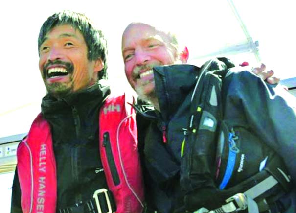 Blind sailor Mitsuhiro Iwamoto (L) celebrates with his navigator Doug Smith.